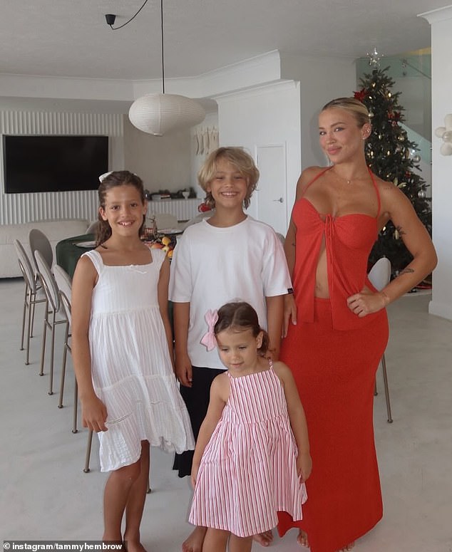 Tammy Hembrow posed inside her Gold Coast home alongside her three children, daughters Saskia and Posy, and son Wolf, in a stunning family portrait