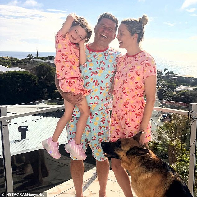 Karl Stefanovic and his wife Jasmine embraced the laidback Aussie Christmas spirit by posing on a sun-drenched balcony with their daughter Harper