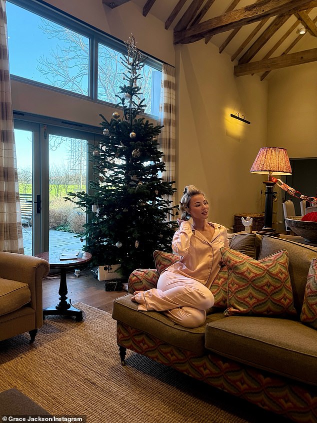 Grace was seen in satin pyjamas with her hair in rollers as she relaxed at home