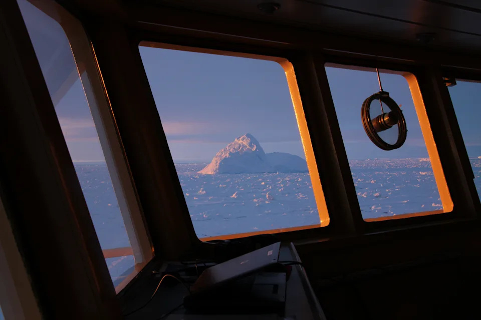  Large iceberg at sunrise, seen from the bridge of an icebreaker.