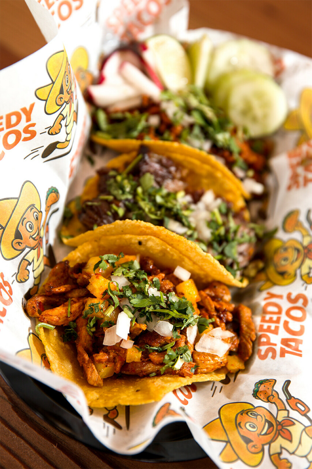 Tacos Callejeros (street tacos) are served on corn tortillas and topped with onion and cilantro. There are a variety of protein choices including trompo, arrachera, tinga de pollo, birria and more.