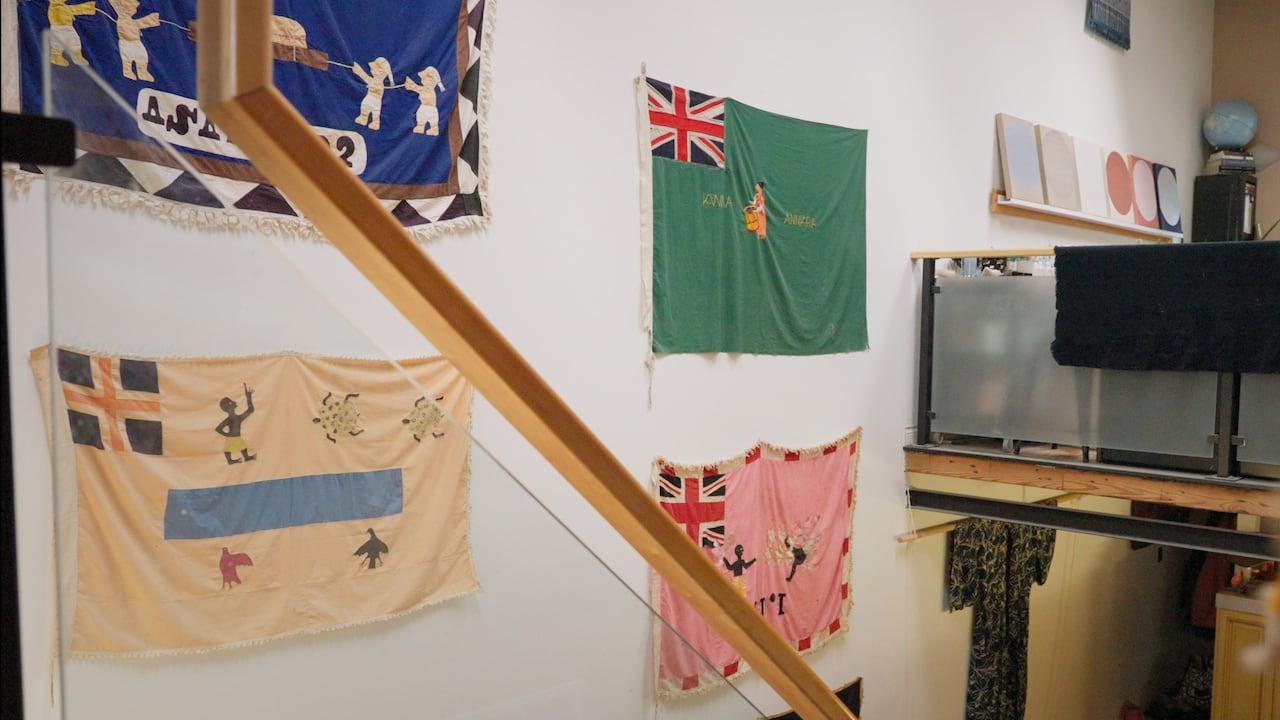 Flags displayed on a wall.