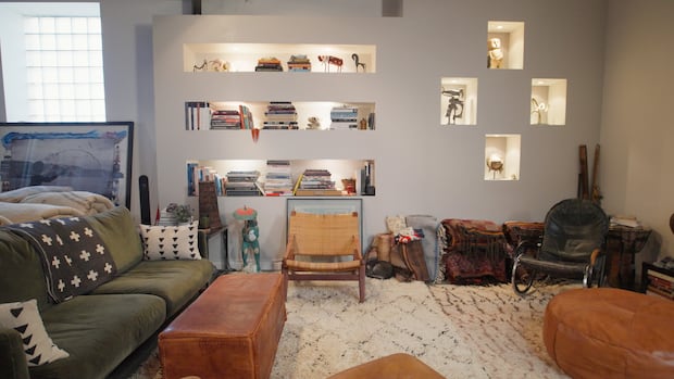 Inside a loft with soaring skylights, sculpture-lined shelves and textiles from floor to ceiling