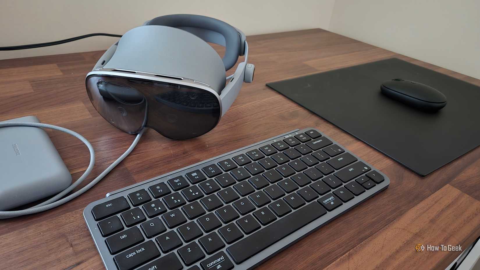 Samsung Galaxy XR headset next to a Bluetooth keyboard and mouse.
