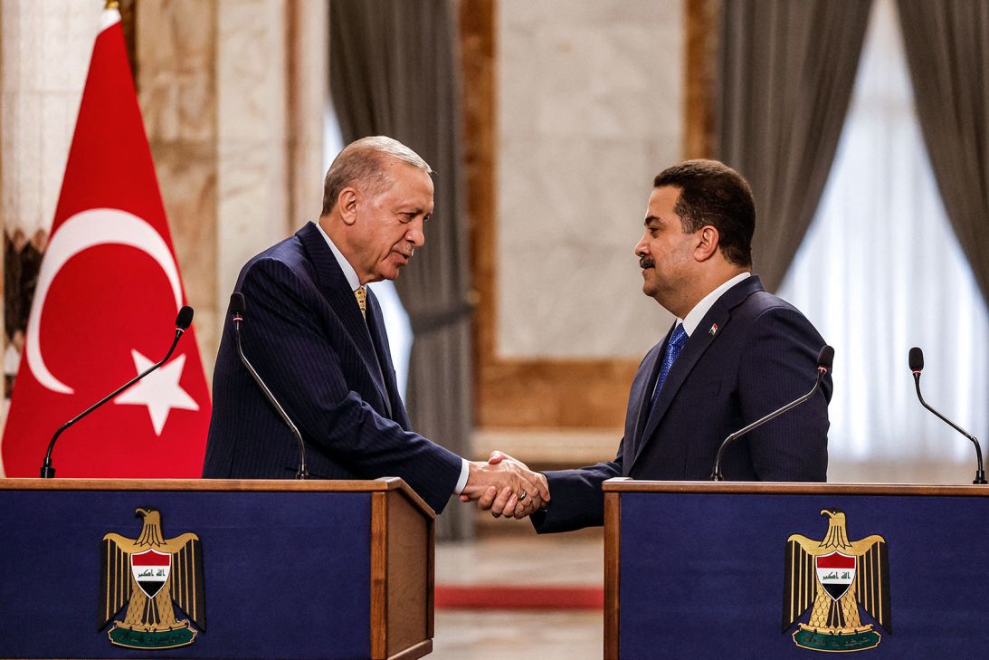 Turkey's President Recep Tayyip Erdogan, left, and Iraq's Prime Minister Mohammed Shia Al-Sudani shake hands in Baghdad on April 22, 2024.