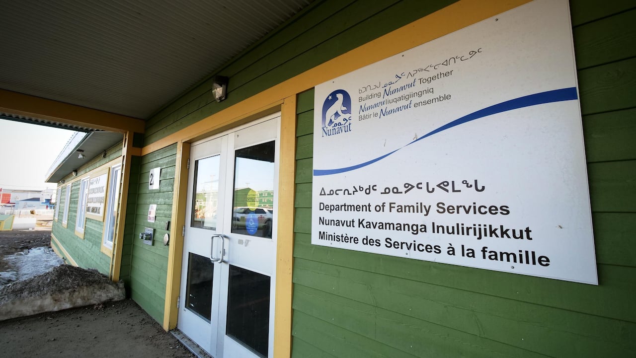 The Department of Family Services building in Iqaluit with green paint and a white sign with lettering out front
