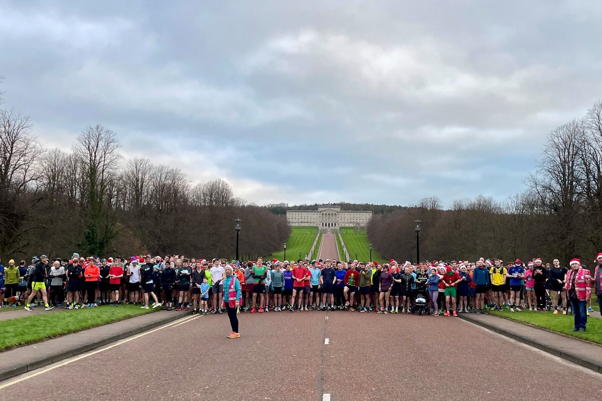 People take part in the festive themed Christmas Day Parkrun at Stormont in Belfast. 