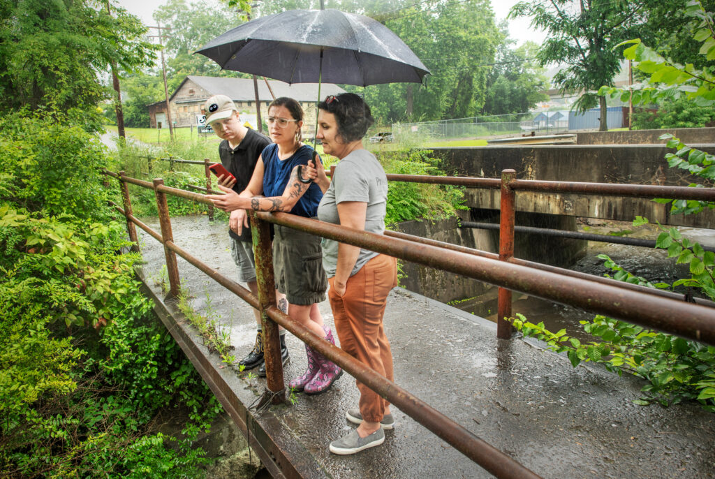 Yvonne Sorovacu (right), Hannah Hohman (center) and Jay Beal monitor a creek for signs of contamination from the Westmoreland Sanitary Landfill in Belle Vernon, Pa.