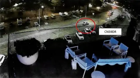 Supplied Grainy CCTV footage shows a darkened road with cars and two deckchairs on a balcony in the foreground