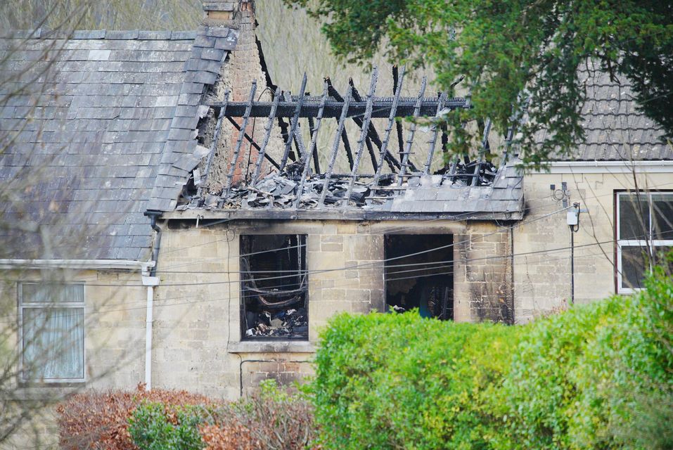 The extent of the fire has caused the roof of the mid-terrace Cotswold stone cottage to fall in (Ben Birchall/PA)