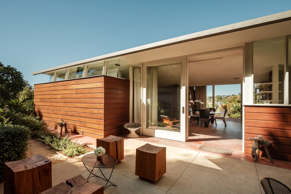 Contemporary outdoor living area featuring wooden elements and modern furnishings.
