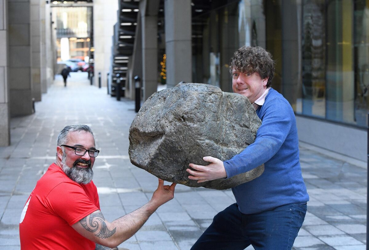  David Keohan teaches Jonathan deBurca Butler the technique for lifting stones using a plastic stone. Photograph Moya Nolan