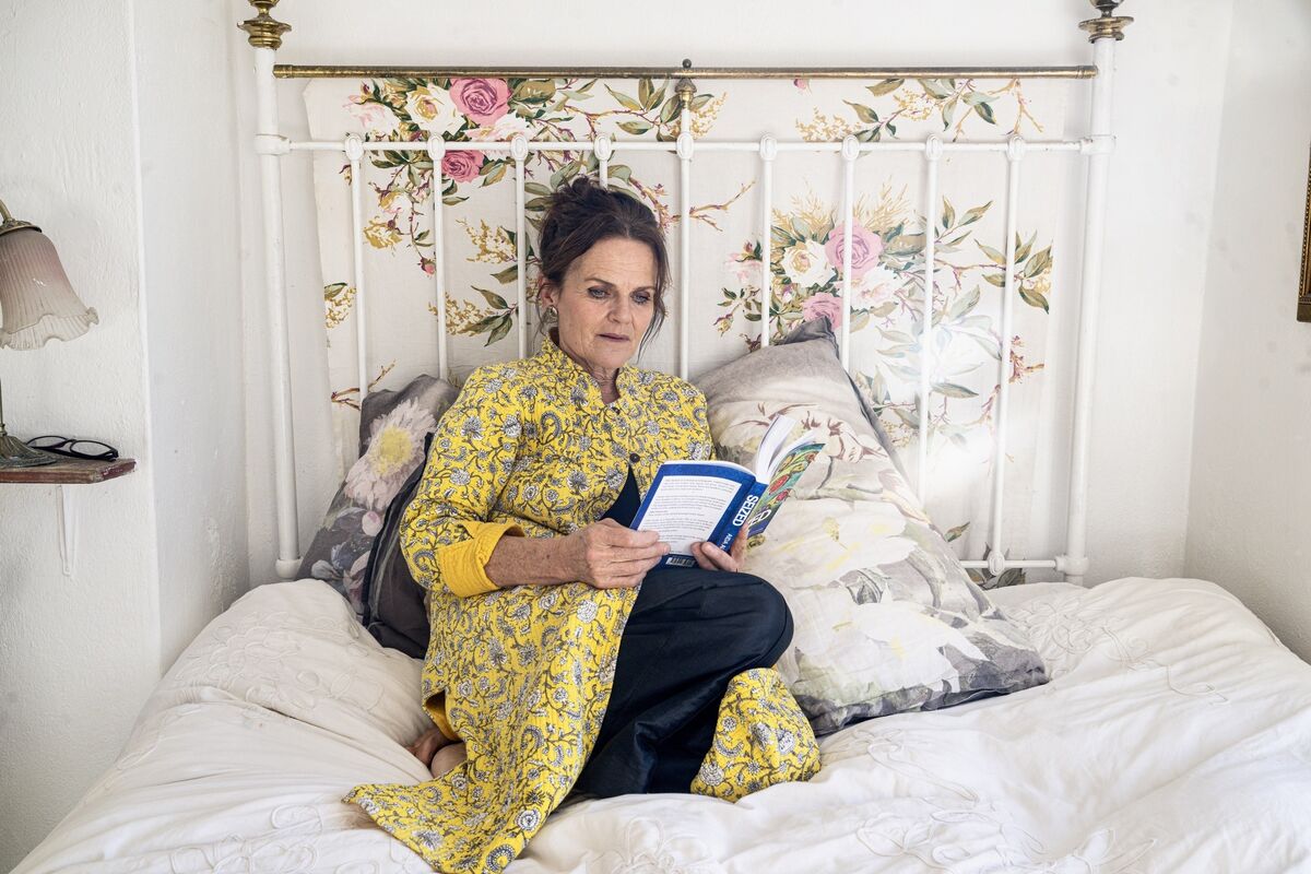 Aida Austin reads on her bed—the very place she wrote Seized—a quiet refuge during years of navigating Iona’s complex epilepsy. “Writing became a way to compartmentalise what felt overwhelming.” Picture Chani Anderson.