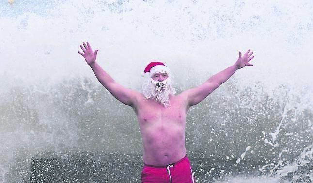 Patrick Corkery from Castleknock plunged into the Forty Foot in Sandycove, Dublin, in a Santa hat and beard.  	Picture: Niall Carson/PA
                    