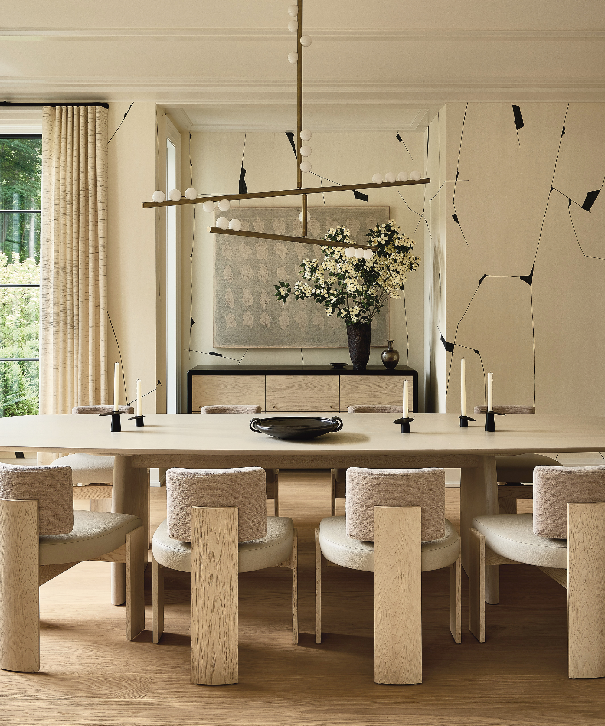 A dining room with a black and white color palette and warm wood-grained furniture.