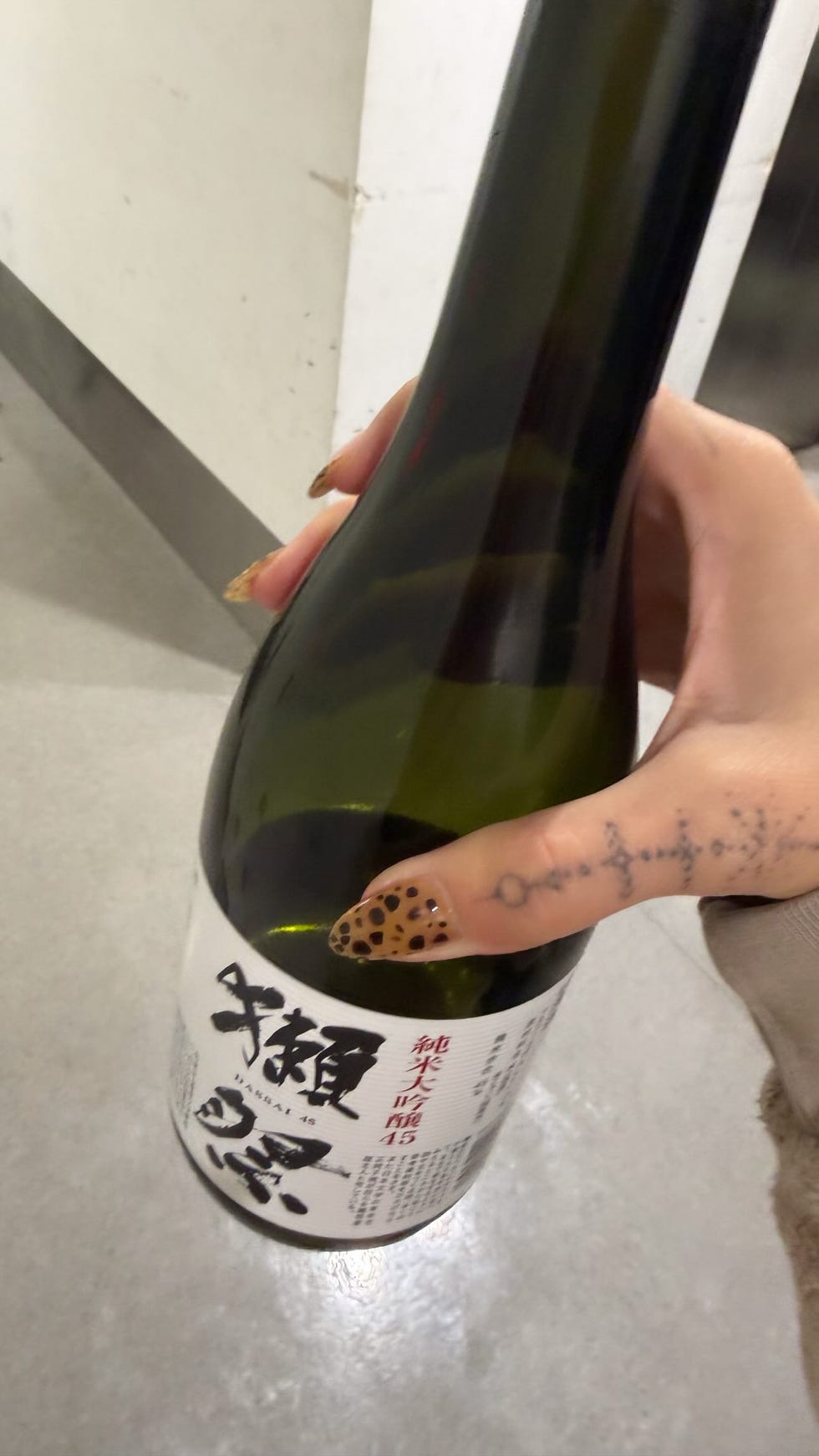 sake bottle held in hand