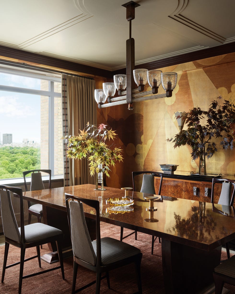 Elegant dining area with a wooden table, chairs, and decorative elements. Elegant dining area with a wooden table, chairs, and decorative elements.