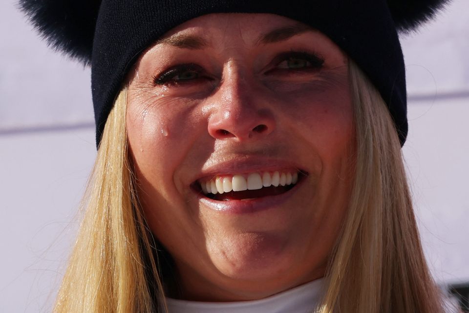 Lindsey Vonn celebrates on the podium after winning the Women's Downhill.