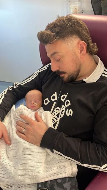 Johnny Smacks with newborn son, J.J.