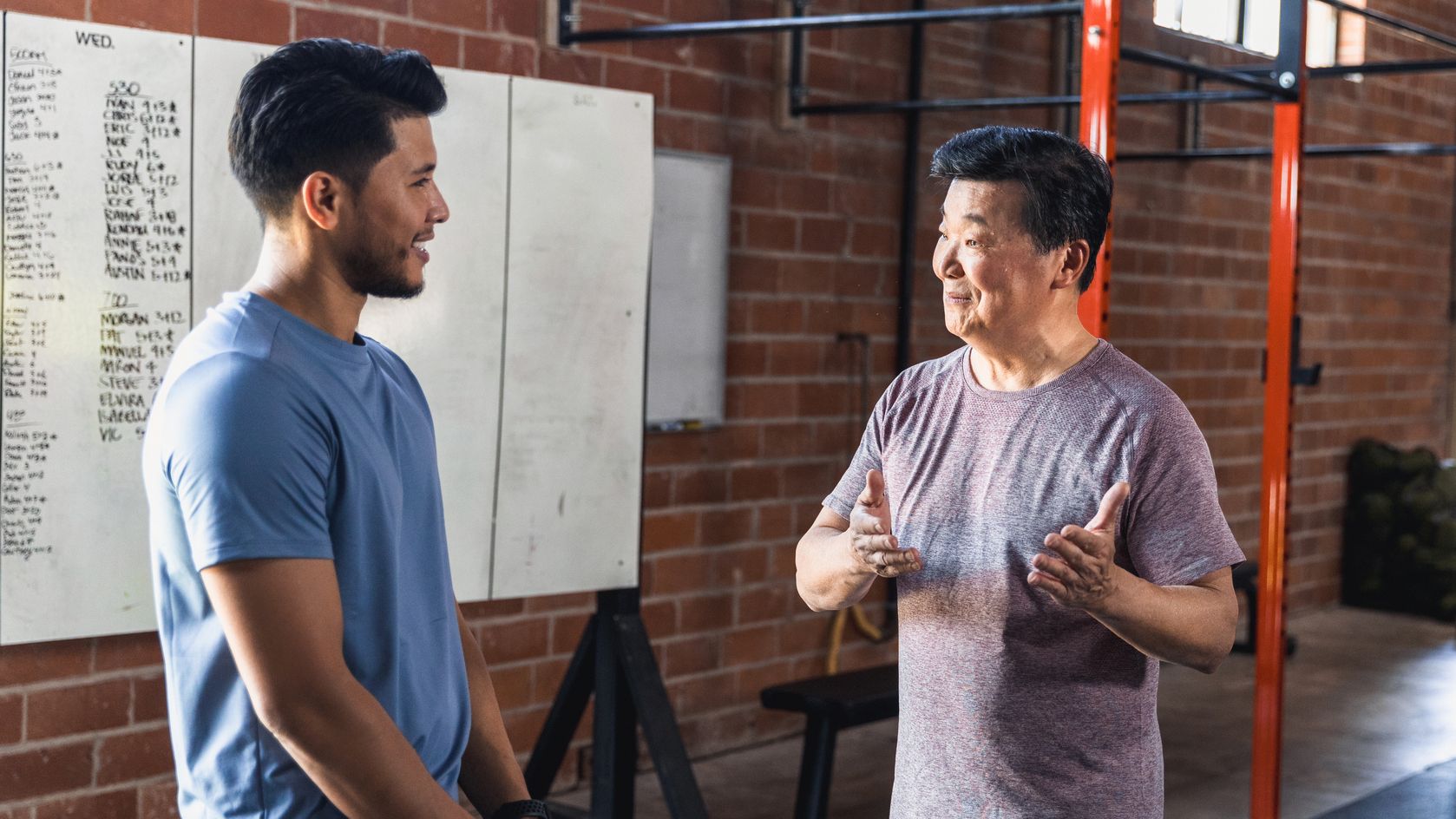 Two men talking in gym setting