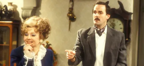Prunella Scales as Sybil Fawlty and John Cleese as Basil Fawlty