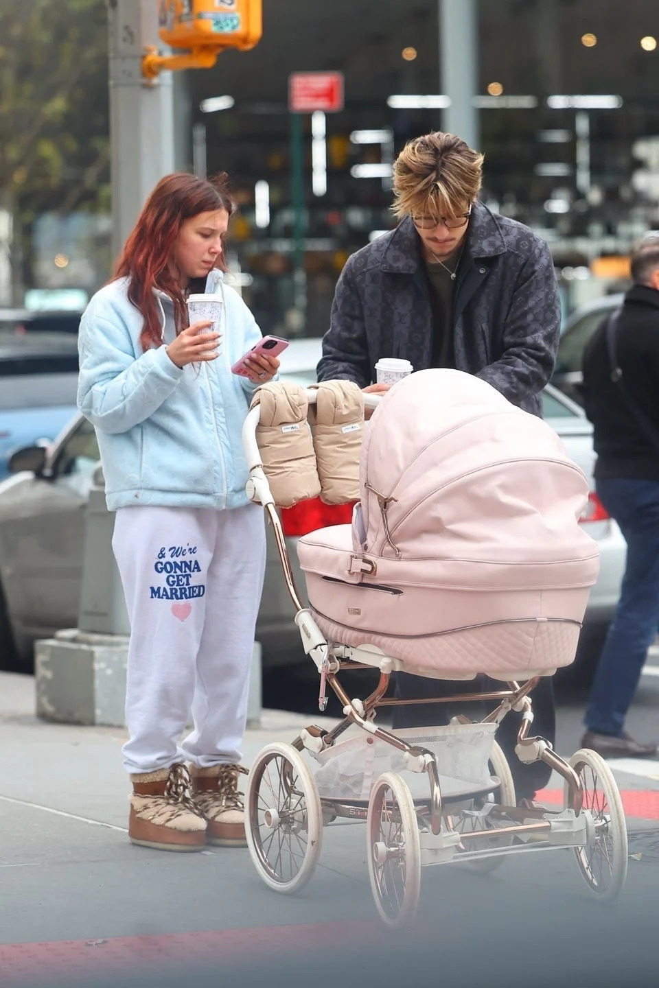 *exclusive* new york, ny **web must call for pricing** millie bobby brown, now known as millie bonnie bongiovi, and husband jake bonjovi were seen this afternoon in the west village, shopping at golden goose while strolling their daughter in a large pink stroller. milie was cozied up wearing chloe x moon boots and pushing their pink cartridge. jake showed off his blonde locks as he grabbed coffee for him and millie. pictured: millie bobby brown, jake bongiovi backgrid usa 10 december 2025 byline must read: blayzenphotos / backgrid usa: +1 310 798 9111 / usasales@backgrid.com uk: +44 208 344 2007 / uksales@backgrid.com *uk clients pictures containing children please pixelate face prior to publication*