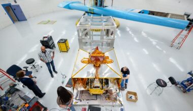 Karen Rogers, left, Orlando Abeyta and Leticia Mercado discuss the testing of the VIPER rover at the Superfuge, while Chad Heitman, right, works on sensors for the test at Sandia National Laboratories. (Photo by Craig Fritz) Click on the thumbnail for a high-resolution image.