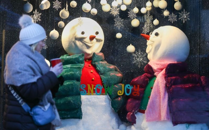 A woman bundled up against the cold weather as she passes the Arnott's Christmas window display on Henry Street in Dublin City Centre in 2022.