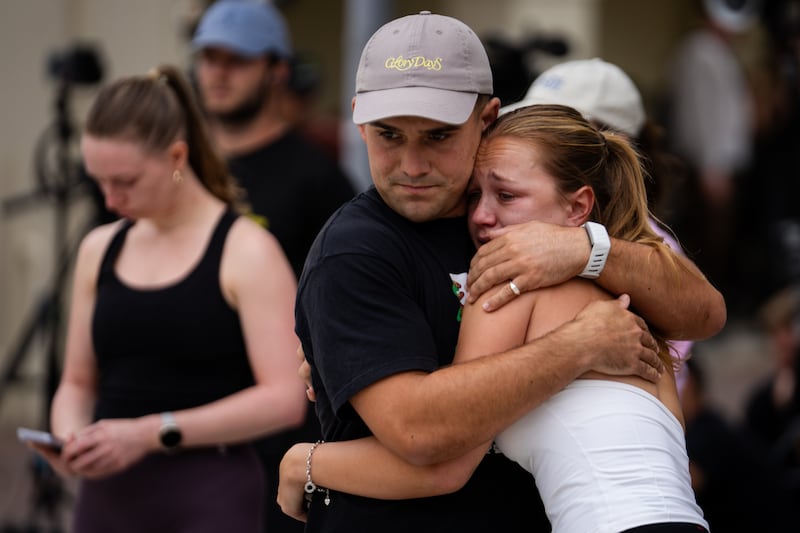 Alfie Orchard and his partner Amy Schanschieff embrace while gathered to mourn at Bondi Pavilion at Bondi Beach. Orchard's rugby team manager, Peter Meagher, was one of the shooting victims. Photograph: Audrey Richardson/Getty Images