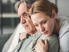 Daughter hugging her father sadly