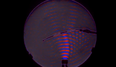 A red and blue visualization of the waves from a small ultrasonic speaker