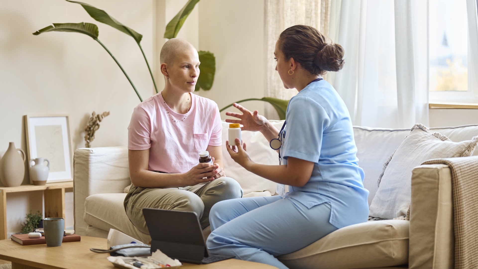 a doctor talks to a woman with cancer