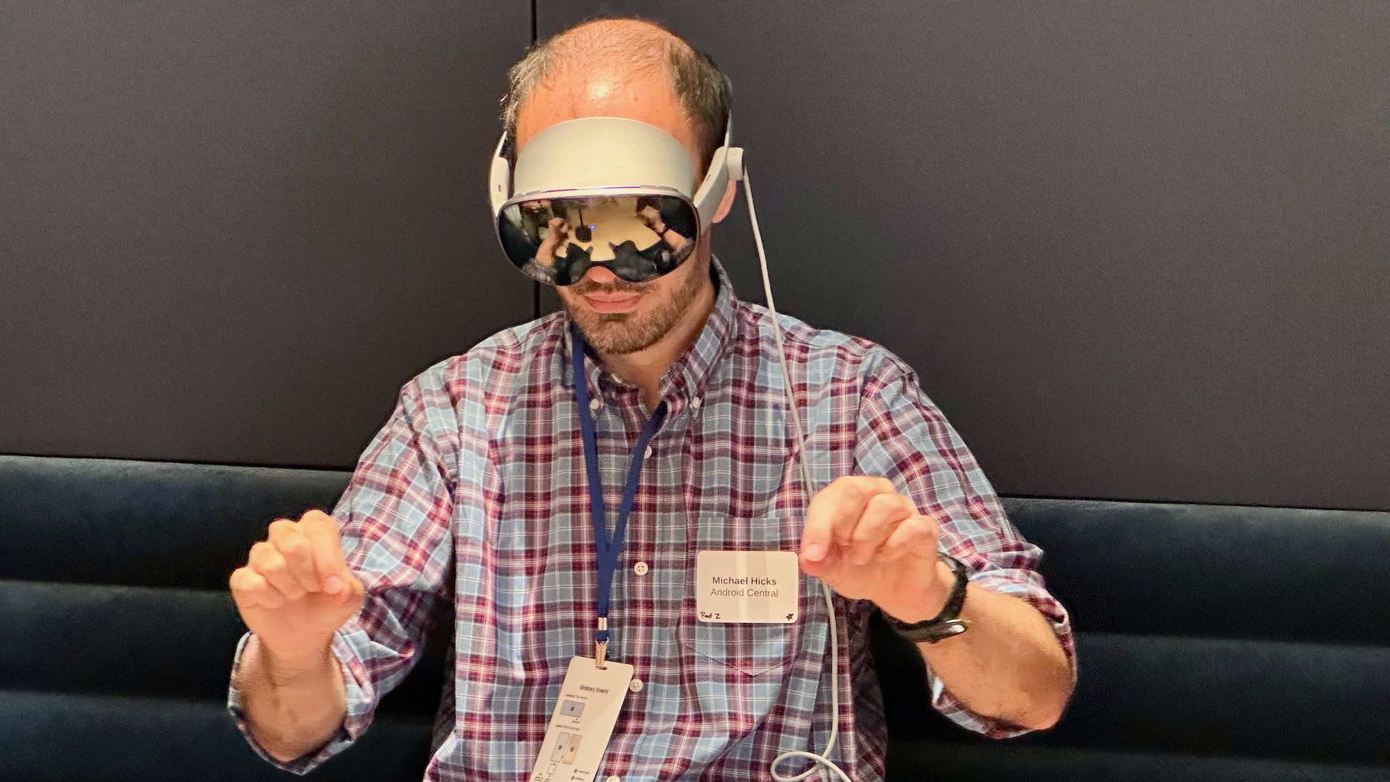 A photo of the author doing a two-handed pinch-to-zoom gesture while wearing the Samsung Galaxy XR headset.