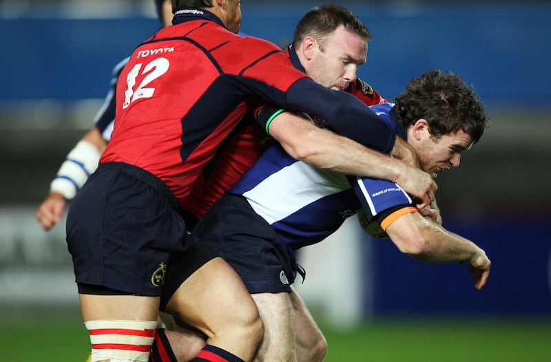 Leinster's Gordon D'Arcy is tackled by John Kelly of Munster in October 2006. Photograph: Billy Stickland/Inpho