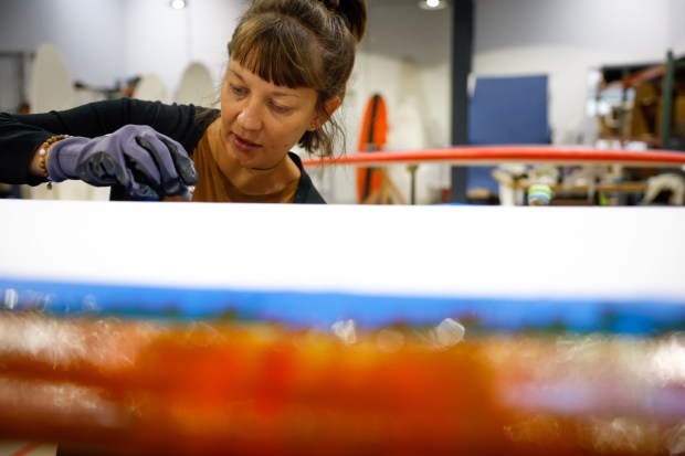Liesbeth Van Hassel works on a board at Swellcycle headquarters in Santa Cruz on Wednesday, Oct. 29, 2025. (Shae Hammond/Bay Area News Group)