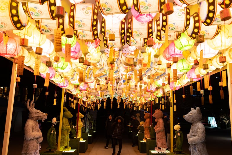 South Korean Buddhist devotees pray at the Jogyesa temple in Seoul on New Year's Eve