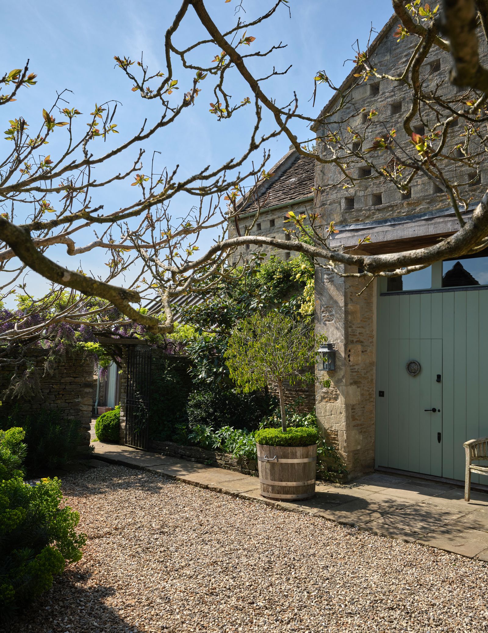 Image may contain Road Architecture Building Housing Outdoors City Street Urban House Plant Tree Path and Chair