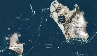 Two large brown and white islands are seen in a dark blue ocean from space with various labels including Vindication Island, Medusa Pool and Lucifer Hill