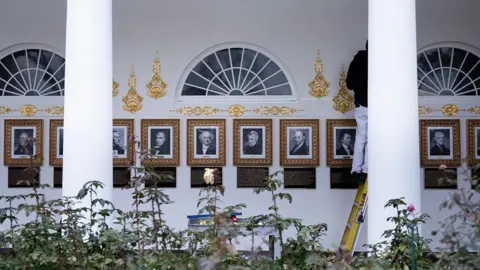 Getty Images A line of portraits of former US presidents outside the West Wing of the White House 