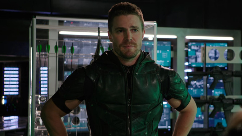 Oliver Queen (Stephen Amell) stands in his Green Arrow costume in Arrow