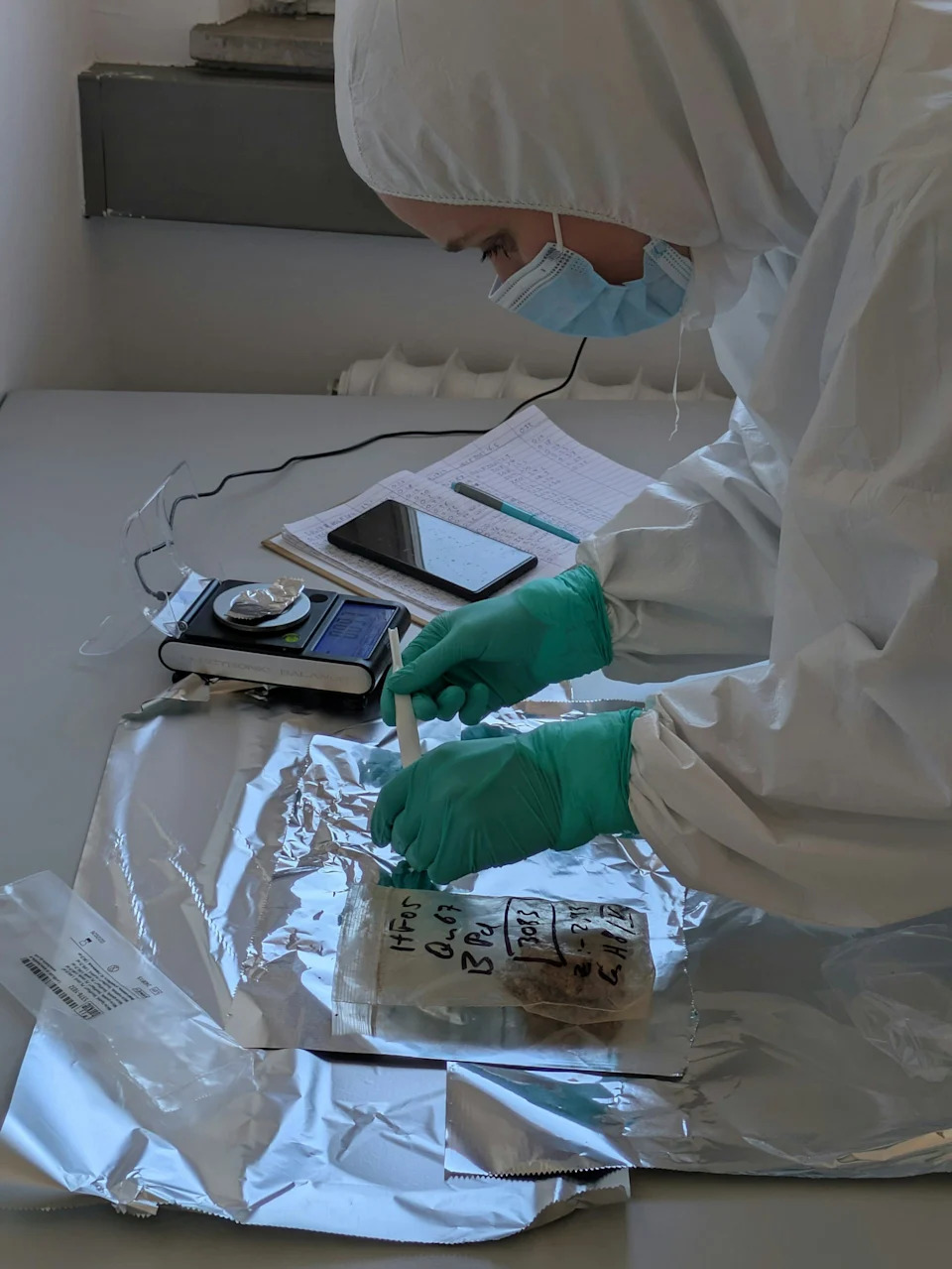 Scientist in a lab looking at the sediment samples.