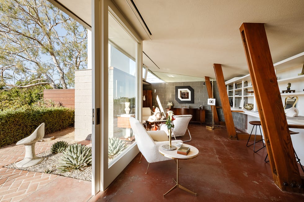 Interior of a modern home with a view of nature through large glass doors.