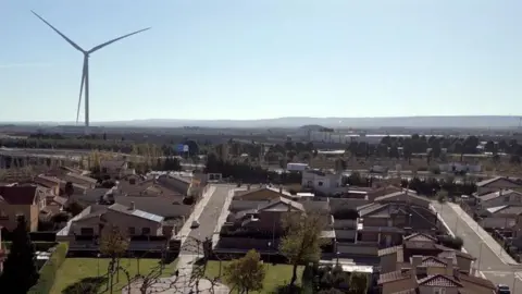 Juan Antonio Domínguez A giant wind turbine standing over the Spanish town of Figueruelas