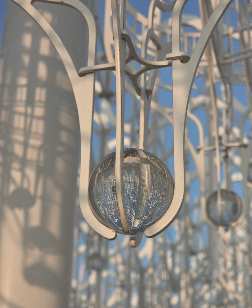 cloud-like white canopy of hanging vines emerges from abu dhabi’s arid landscape