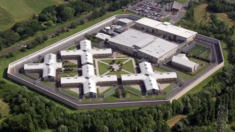 BBC Aerial image of a prison surrounded by trees.
