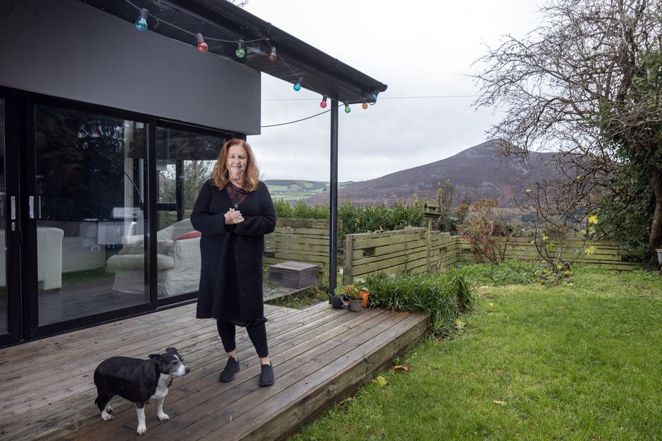 Singer Mary Coughlan with her dog Connie on the deck of her Co Wicklow home with views of the Sugar Loaf in the background. Photo: Tony Gavin