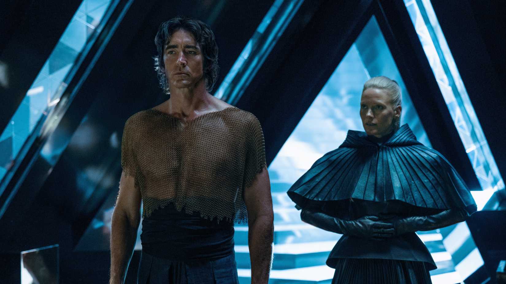 Lee Pace and Laura Birn standing in a bright hallway in Foundation