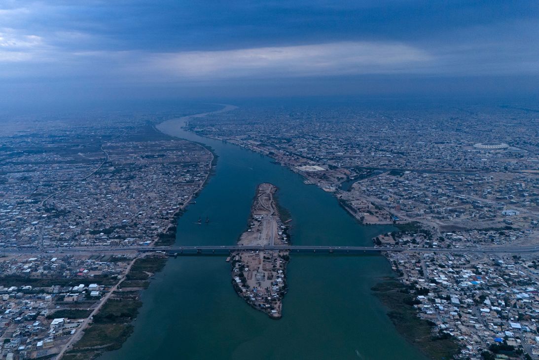 An aerial picture shows Sinbad island and the Khaled bridge on the Shatt al-Arab waterway, formed at the confluence of the Euphrates and Tigris rivers, in Iraq's southern city of Basra on December 4, 2024.