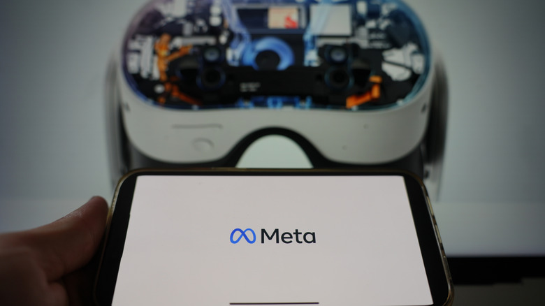 Mobile phone with the Meta Quest in the background