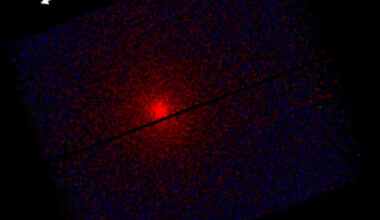 This XMM-Newton image shows an X-ray view of the interstellar comet 3I/ATLAS. At the center of the image, a bright red spot stands out against a dark background, like a fiery beacon. Starting from this core, faint gradients of purple and blue spread outward, creating a slightly rotated rectangular frame, divided by a thin horizontal line, the detector gap. The red color shows low-energy X-rays, blue marks empty space with very few X-rays. Image credit: ESA / XMM-Newton / C. Lisse / S. Cabot / XMM ISO Team.